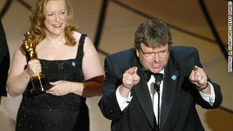 Filmmaker Michael Moore accepts his Oscar for Documentry Feature for &quot;Bowling for Columbine&quot; during the 75th Academy Awards at the Kodak Theatre in Hollywood, California, 23 March 2003.  AFP PHOTO  TIMOTHY A. CLARY        (Photo credit should read TIMOTHY A. CLARY/AFP via Getty Images)