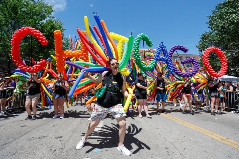 Participants carry balloons spelling out "Chicago" during the 51st LGBTQ Pride Parade in Chicago, Illinois, on June 26, 2022. - The Pride Parade returned to the Lakeview and Uptown neighborhoods after a three year hiatus due to the coronavirus pandemic.