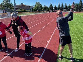 Mark Lyons shoots off the starter's pistol in a Special Olympics event that now bears his son's name.
Greg Estabrooks/The Nugget