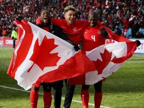 Canadian players celebrate after qualifying for the World Cup 2022 in Qatar after beating Jamaica 4-0 in March.