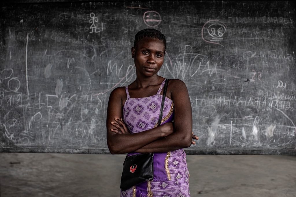 Dorika, North Kivu, Democratic Republic of Congo © Finbarr O'Reilly for Fondation Carmignac / ICC A survivor of rape in conflict, Dorika, now 18, makes and sells clothes for a living. She plans to save enough money to buy her own small plot of land to build a home for herself and her daughter.