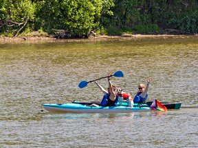 Participants in Paddle for Pride make their way down the Grand River from Onondaga, Ontario heading to Chiefswood Park on Six Nations of the Grand River Territory on Saturday.