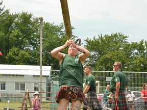 Heather Boundy, the Guinness World Record holder for most cabers thrown in three minutes (15), competed in the heavy events at the Embro Highland Games Friday. Pictured, Boundy demonstrates her caber toss. (Galen Simmons/The Beacon Herald)